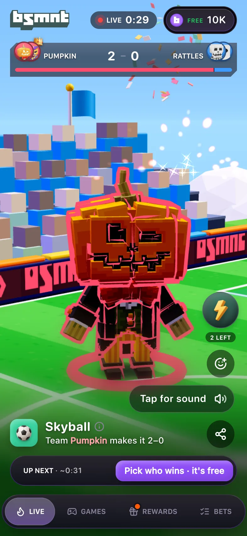 Live Skyball card with Pumpkin's squad up 2-0, a Tap for sound invite beside the action buttons, a purple hint reading Pick who wins, it's free on the Up next strip at the bottom, and the balance chip reading Free 10K